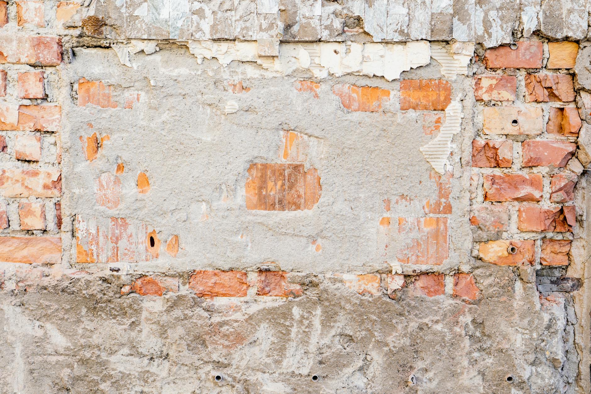 Close-up of a vintage brick and concrete wall showing texture and wear in Rosenheim, Germany.